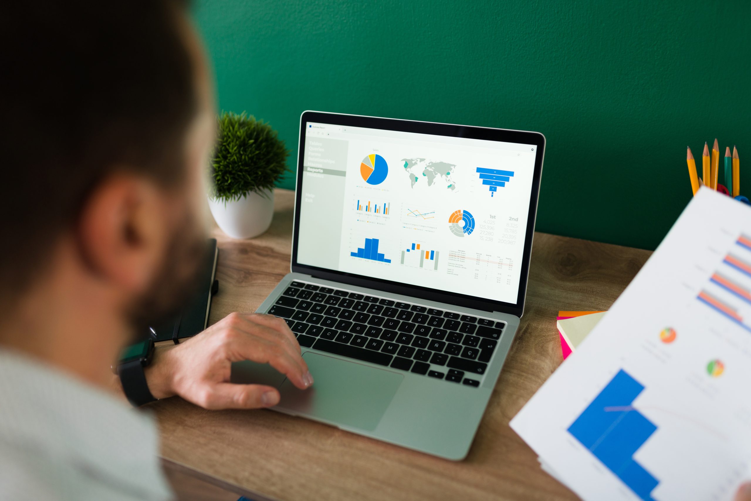Man analyzing data on laptop screen