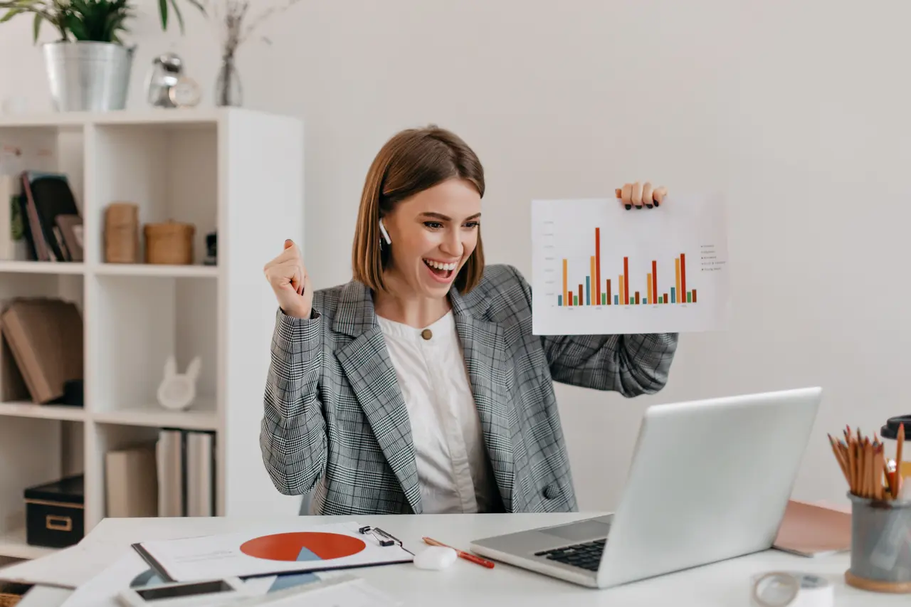 Businesswoman celebrating growth analytics report