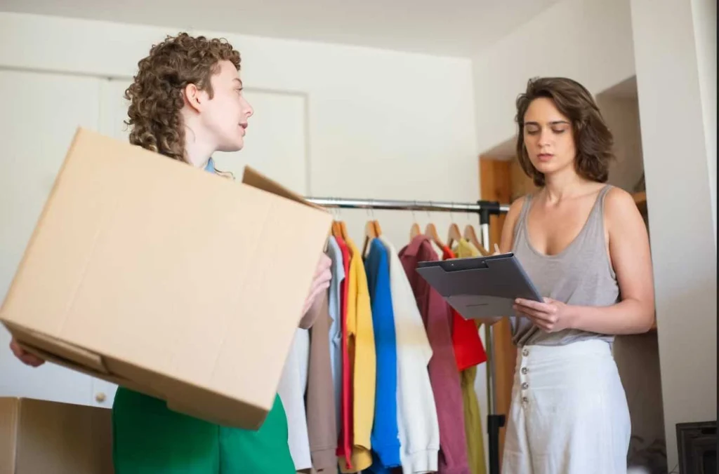 clothing inventory manager checking stock with boxes