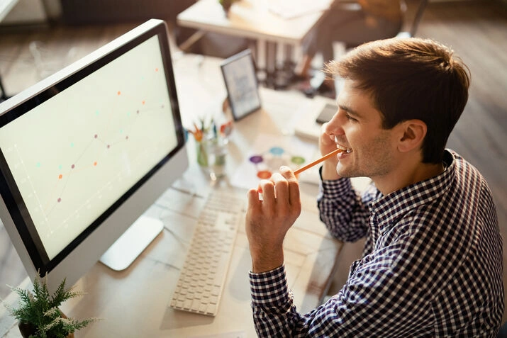 SEO analyst reviewing website performance and marketing data on computer