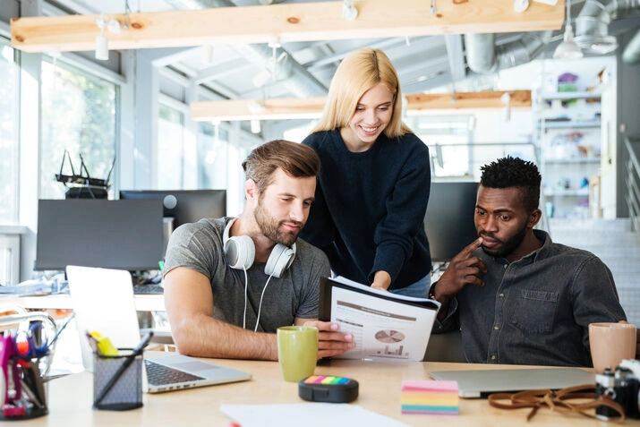 Creative team reviewing business report and analytics