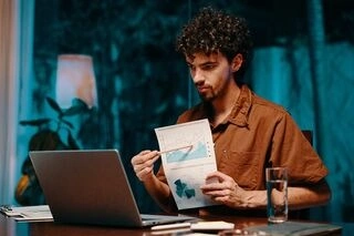 Writer reviewing book layout on laptop